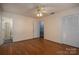 Light beige bedroom with wood floors, ceiling fan, and access to bathroom at 1890 Rhyneland Rd, Lincolnton, NC 28092