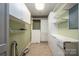 Laundry room with white cabinets and shelving at 1890 Rhyneland Rd, Lincolnton, NC 28092