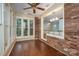 Sunroom with hardwood floors, brick wall, and kitchen pass-through at 1890 Rhyneland Rd, Lincolnton, NC 28092