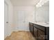 Double vanity bathroom with ample storage and neutral tile floors at 9415 Kendall Dr, Charlotte, NC 28214