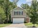 Two-story house with neutral siding, stone accents, and a two-car garage at 9415 Kendall Dr, Charlotte, NC 28214