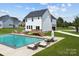 Relaxing backyard oasis featuring a refreshing pool, spacious patio, and comfortable lounge chairs at 103 Dublin Ct, Statesville, NC 28677