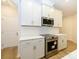 Stylish kitchen featuring white cabinets, stainless steel appliances, and quartz countertops at 140 Halite Ln, Waxhaw, NC 28173