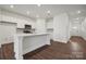 Modern kitchen with white cabinets, a large island, and stainless steel appliances at 2544 Blue Sky Meadows Dr, Monroe, NC 28110