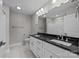 Double vanity bathroom with dark countertop and tile floor at 103 Dublin Ct, Statesville, NC 28677