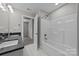 Bathroom features a bathtub, double vanity, and dark countertop at 103 Dublin Ct, Statesville, NC 28677