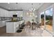 Modern kitchen with island, white cabinets, and breakfast nook at 103 Dublin Ct, Statesville, NC 28677
