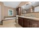 Double vanity bathroom with soaking tub and tile at 7053 Quailwood Dr, Stanley, NC 28164