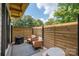 Small patio with wooden privacy fence and seating area at 1498 Robinwood Rd, Gastonia, NC 28054