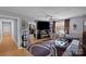 Living room featuring hardwood floors, a large TV, and comfy seating at 2110 E Greenbriar Rd, Statesville, NC 28625