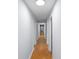 Long hallway with light walls and wood flooring at 2110 E Greenbriar Rd, Statesville, NC 28625
