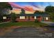 Brick ranch house with solar panels and a green door at 2110 E Greenbriar Rd, Statesville, NC 28625