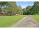 Gravel driveway leading to charming ranch home nestled in woods at 2110 E Greenbriar Rd, Statesville, NC 28625