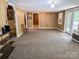 Spacious living room with wood paneling, carpet, and multiple entrances at 2575 West View Acres Avenue Ext, Hickory, NC 28601