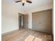 Bedroom with hardwood floors, ceiling fan and double doors to closet at 166 Tranquility Ln # 24, Harmony, NC 28634