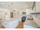 Modern kitchen with granite countertops, white cabinets, and stainless steel appliances at 166 Tranquility Ln # 24, Harmony, NC 28634