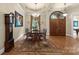 Bright dining room features hardwood floors and a large chandelier at 4364 Hager Mountain Ln, Iron Station, NC 28080