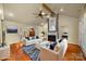 Virtually staged living room with hardwood floors and a fireplace at 4364 Hager Mountain Ln, Iron Station, NC 28080