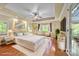 Virtually staged main bedroom with hardwood floors and large windows at 4364 Hager Mountain Ln, Iron Station, NC 28080