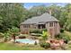 Inviting pool area with lush landscaping and patio furniture at 4364 Hager Mountain Ln, Iron Station, NC 28080