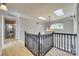 Upstairs hallway with skylights, chandelier, and black railing at 164 Quiet Cove Rd, Mooresville, NC 28117