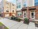 Brick townhome with front entrance, landscaping, and sidewalk at 448 E 16Th St, Charlotte, NC 28206