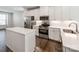 Modern kitchen with white cabinets, stainless steel appliances, and island at 448 E 16Th St, Charlotte, NC 28206