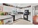 Modern kitchen with white cabinets and black appliances at 8018 Maxwelton Dr, Huntersville, NC 28078