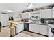 Modern kitchen with white cabinets and black appliances at 8018 Maxwelton Dr, Huntersville, NC 28078