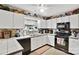 Modern kitchen with white cabinets and black appliances at 8018 Maxwelton Dr, Huntersville, NC 28078