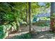 Wooded backyard with string lights and a partially fenced area at 8018 Maxwelton Dr, Huntersville, NC 28078