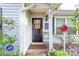 Inviting front entry with a black door and a small porch at 8018 Maxwelton Dr, Huntersville, NC 28078