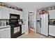 Modern kitchen with white cabinets and black appliances at 8018 Maxwelton Dr, Huntersville, NC 28078