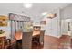Well-lit dining room featuring a wooden table and six chairs at 8018 Maxwelton Dr, Huntersville, NC 28078
