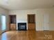 Living room with hardwood floors, fireplace and built-in shelving at 13706 Morehouse St, Huntersville, NC 28078