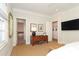 Bright bedroom with hardwood floors, ensuite bathroom access, and built-in shelving at 348 S Laurel Ave, Charlotte, NC 28207