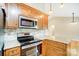 Stainless steel range and microwave in a kitchen with granite countertops at 2497 Carriage Ln, Lincolnton, NC 28092