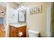 Bathroom featuring granite vanity, framed mirror, and linen closet at 2497 Carriage Ln, Lincolnton, NC 28092