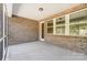 Screened porch with brick walls and concrete flooring at 3617 Marchers Trace Dr, Mint Hill, NC 28227