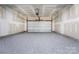 Unfinished garage with grey epoxy flooring at 812 Hardin St, Lancaster, SC 29720