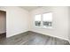 Bedroom with grey wood-look floors and double window at 812 Hardin St, Lancaster, SC 29720