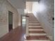 Staircase with floral wallpaper and wood flooring at 222 Leak Ave, Wadesboro, NC 28170