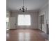 Empty dining room with hardwood floors, fireplace, and chandelier at 222 Leak Ave, Wadesboro, NC 28170