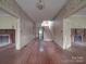 Large entryway with hardwood floors, staircase, and fireplace at 222 Leak Ave, Wadesboro, NC 28170