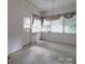 Bright sunroom with multiple windows and brick wall at 222 Leak Ave, Wadesboro, NC 28170