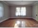 Bright bedroom with hardwood floors and large windows at 222 Leak Ave, Wadesboro, NC 28170