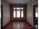 Front entry with hardwood floors and floral wallpaper at 222 Leak Ave, Wadesboro, NC 28170