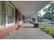 Large front porch with brick columns and wooden floor at 222 Leak Ave, Wadesboro, NC 28170