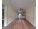 Long hallway with hardwood floors and vintage ceiling details at 222 Leak Ave, Wadesboro, NC 28170