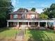 Brick two-story house with a front porch and landscaped yard at 222 Leak Ave, Wadesboro, NC 28170